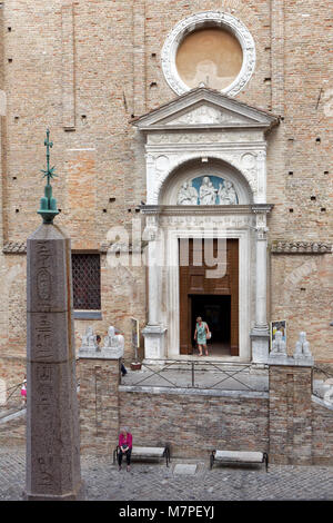 Urbino, Italy - June 14, 2017: People at the Gothic church of San Domenico and Egyptian obelisk. This is one of the twelve original Egyptian obelisks  Stock Photo