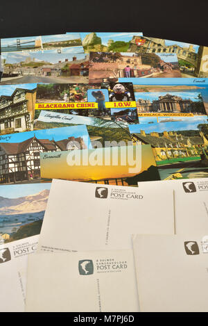 A selection of J Salmon Ltd postcards depicting English and Welsh views, shown on a black background. Stock Photo