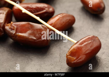 Sweet dates on a slate surface closeup Stock Photo