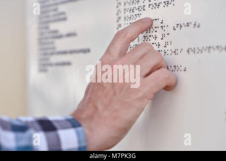 Man reading the Braille plate Stock Photo
