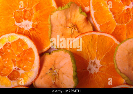 Close-up of dried orange and apple slices.  The fruit fills the whole frame. Horizontal photo. Stock Photo