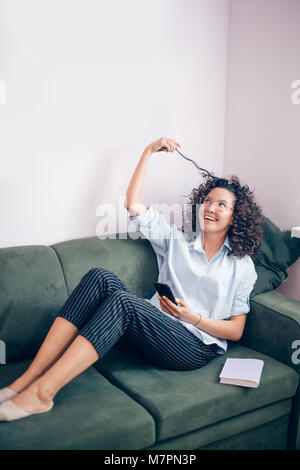 young woman is enthusiastic about wavy hair. being delighted after new haircut, being glad after dyeing hair Stock Photo