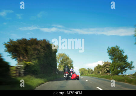 A motorbike and sidecar travel around the Isle of Man during the 100 Centenary TT Races on the Isle of Man.   http://www.iomtt.com/History.aspx Stock Photo