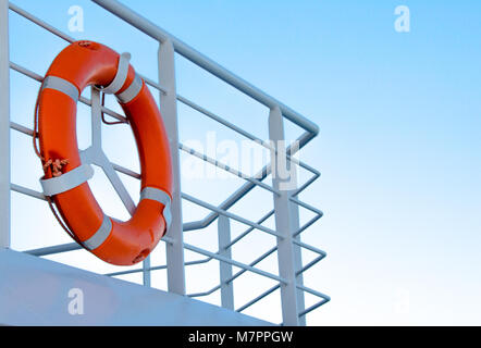 Orange Lifebuoy in front of the blue sky Stock Photo