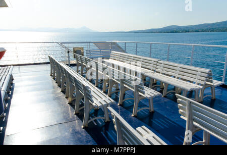 Plastic white seats in a row upon a ferry boat Stock Photo