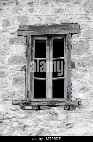 Old wooden window on stone made wall. Stock Photo