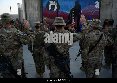 U.S. Airmen assigned to the 455th Air Expeditionary Wing take reenlistment oath during a Patriot’s Day ceremony at Bagram Airfield, Afghanistan Sept. 11, 2014.  Airmen participated in a Patriot's Day Retreat and reenlistment ceremony Sept. 11, 2014.  Patriot's Day is an annual observance to remember those who were injured or died during the attacks on Sept. 11, 2001. (U.S. Air Force photo by Staff Sgt. Evelyn Chavez/Released) 455th Air Expeditionary Wing Bagram Airfield, Afghanistan Stock Photo