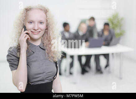 female assistant talking on mobile phone in office Stock Photo