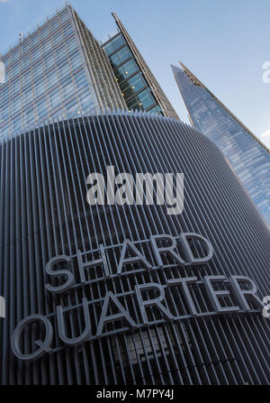 A different and unusual view of the shard office building in central london with the shard quarter sign on a modern contemporary building in the front Stock Photo