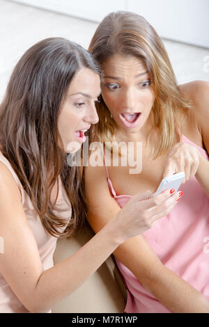 two beautiful students watching phone Stock Photo
