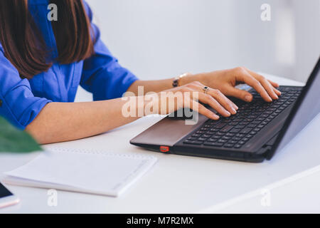 female hands closeup, typing on laptop keyboard. Stock Photo
