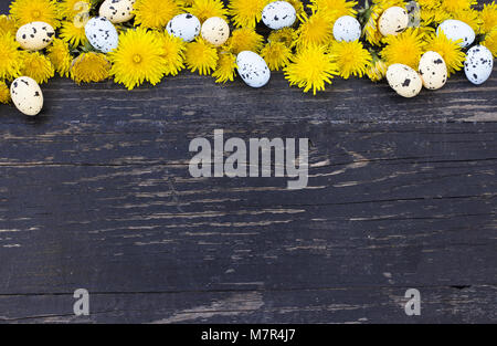 Colorful Easter eggs upper edge over dark wooden background Stock Photo