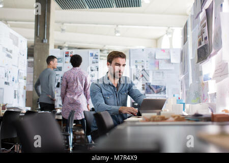 Designers working in an open plan office space Stock Photo