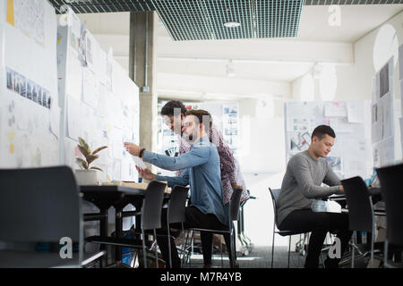 Designers working in an open plan office space Stock Photo