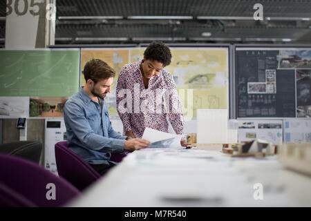 Architects looking at plans Stock Photo