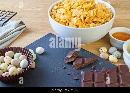 Easter corn flake cake baking ingredients with mini chocolate eggs Stock Photo