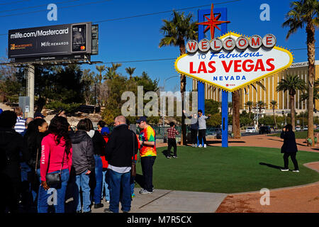 Tourists having photograph next to Famous Sign welcome to Las Vegas,Nevada,USA