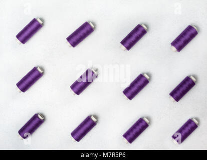 rows of violet spools of thread. view from above Stock Photo