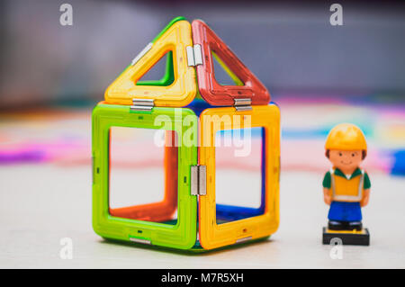 Construction worker and building industry concept. Toy house miniature. Miniature colorful plastic toy house Colorful house. Toy house for any concept Stock Photo