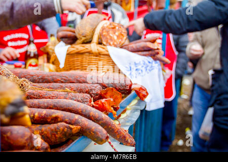 Selling cured meat and sausages, salami for sale at outdoor flea market. Stock Photo