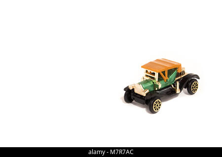 Old fashioned green and gold car with copy space to the left. Stock Photo