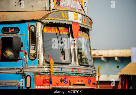 Agra-Jaipur Route NH21: Brightly painted cab of a truck which is a travelling home to it's driver,  Elaborately decorated for luck and safe travels Stock Photo