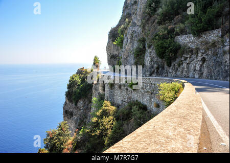 Breathtaking views along the Amalfi Coast route. Winding road, sheer cliffs, azure blue sea. 50km route between Amalfi village and Sorrento in Italy Stock Photo