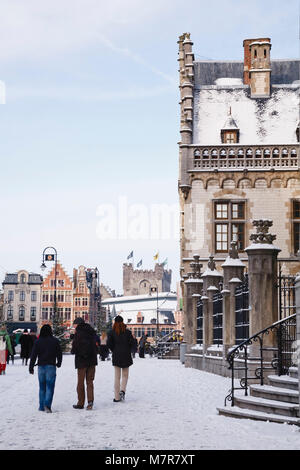 Ghent, Belgium - December 18, 2010. Tourists walk along Graslei in snow, winter in central Ghent, Belgium. Stock Photo