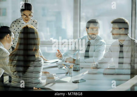 Considerate female boss listening to her employees concerns Stock Photo