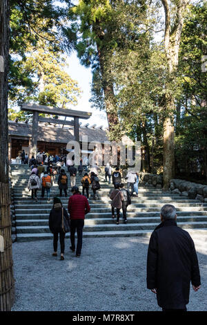 Japan, Ise Grand Shrine, Naiku, inner shrine. Torii gate and steps to wooden shrine, with many people. Stock Photo