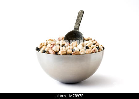 Uncooked assorted legumes with spoon in metal bowl isolated on white background. Copyspace Stock Photo