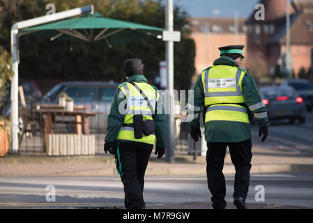 civil enforcement traffic wardens walking down street together Stock Photo