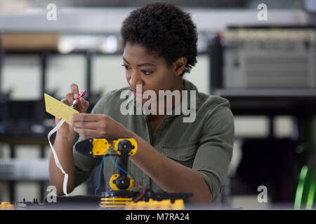 Female working on robotics Stock Photo