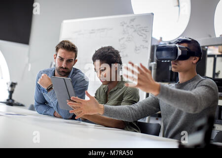 Team working on virtual reality headset Stock Photo