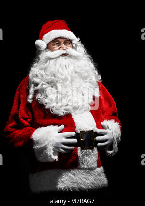 Portrait of cheerful santa claus with hands on stomach Stock Photo