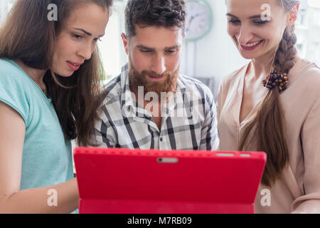 Reliable digital nomads helping their co-worker during remote work Stock Photo
