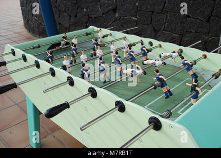 Figures of football players from metal, in blue-red form. Table soccer. Stock Photo