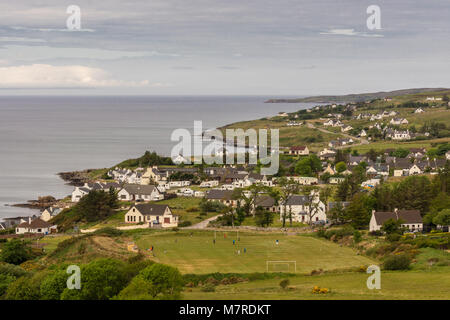 Aultbea, Scotland - June 9, 2012: Aerial view on the village with soccer field and players in front. Gray waters of Loch Ewe on left, and green hills  Stock Photo