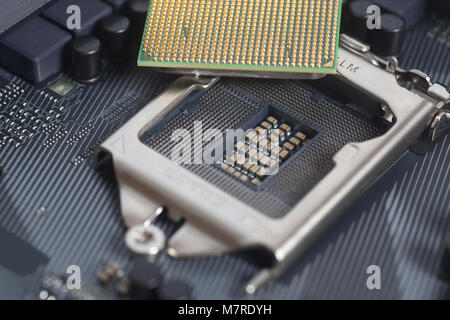 Intel LGA 1151 cpu socket on motherboard Computer PC with cpu processor close up Stock Photo