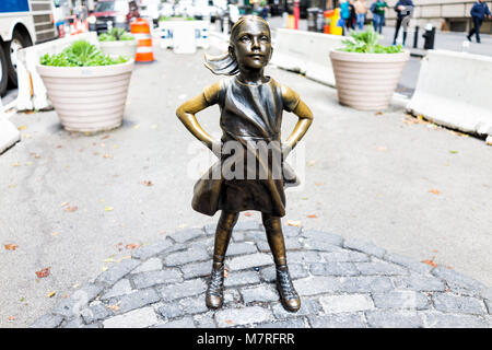 New York City, USA - October 30, 2017: Wall Street stock exchange The Fearless Girl statue facing Charging Bull metal in NYC Manhattan lower financial Stock Photo