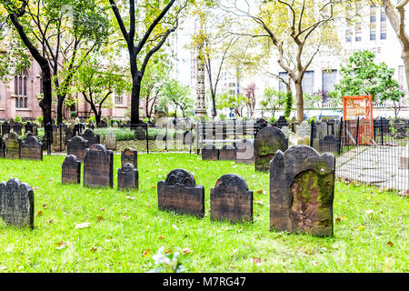 New York City, USA - October 30, 2017: Trinity Church graveyard cemetery in NYC Manhattan lower financial district downtown, NYSE, green grass, graves Stock Photo