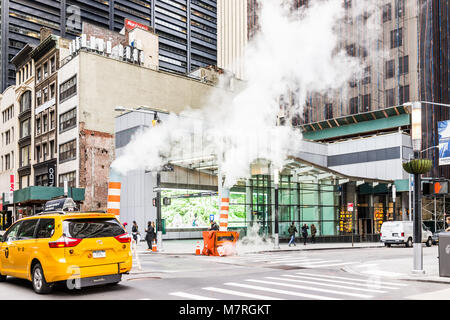 New York City, USA - October 30, 2017: People walking on Broadway St by Wall Street in NYC Manhattan lower financial district downtown, smoke steam co Stock Photo