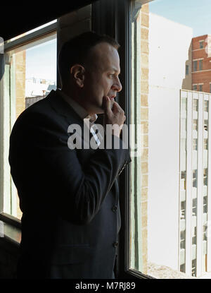 Taoiseach Leo Varadkar looks out of the 7th floor window of the Dallas County Administration Building in Dealey Plaza, downtown Dallas, a floor above primary crime scene for the 1963 JFK shooting after evidence of a sniper was found on the sixth floor, known then as the Texas School Book Depository, as part of his visit to the United States. Stock Photo