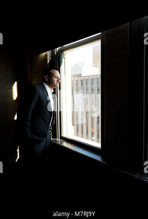 Taoiseach Leo Varadkar looks out of the 7th floor window of the Dallas County Administration Building in Dealey Plaza, downtown Dallas, a floor above primary crime scene for the 1963 JFK shooting after evidence of a sniper was found on the sixth floor, known then as the Texas School Book Depository, as part of his visit to the United States. Stock Photo