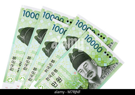 Several Korean 10000 Won currency bills isolated on a white background. Stock Photo