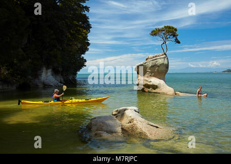 Kayaker and swimmers, Tinline Bay, Abel Tasman National Park, Nelson ...