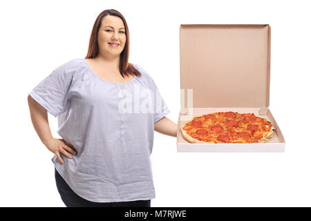 Overweight woman holding a pizza and smiling isolated on white background Stock Photo