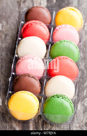 colorful  macarons on rustic wooden backrgound Stock Photo