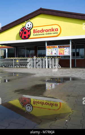 Parked shopping carts equipped with coin-operated locking mechanisms in Biedronka supermarket in the beginning of law restriction for Sunday shopping  Stock Photo