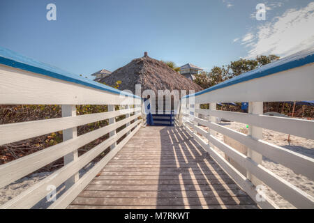 Boardwalk across the White sand beach and aqua blue water of Clam Pass in Naples, Florida in the morning. Stock Photo